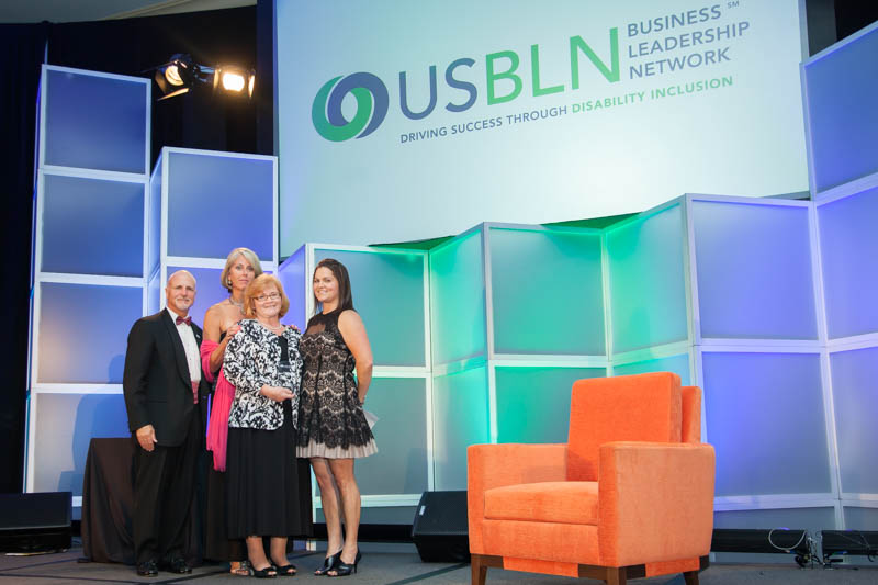 Group of women standing on a stage at the USBLN conference in 2014